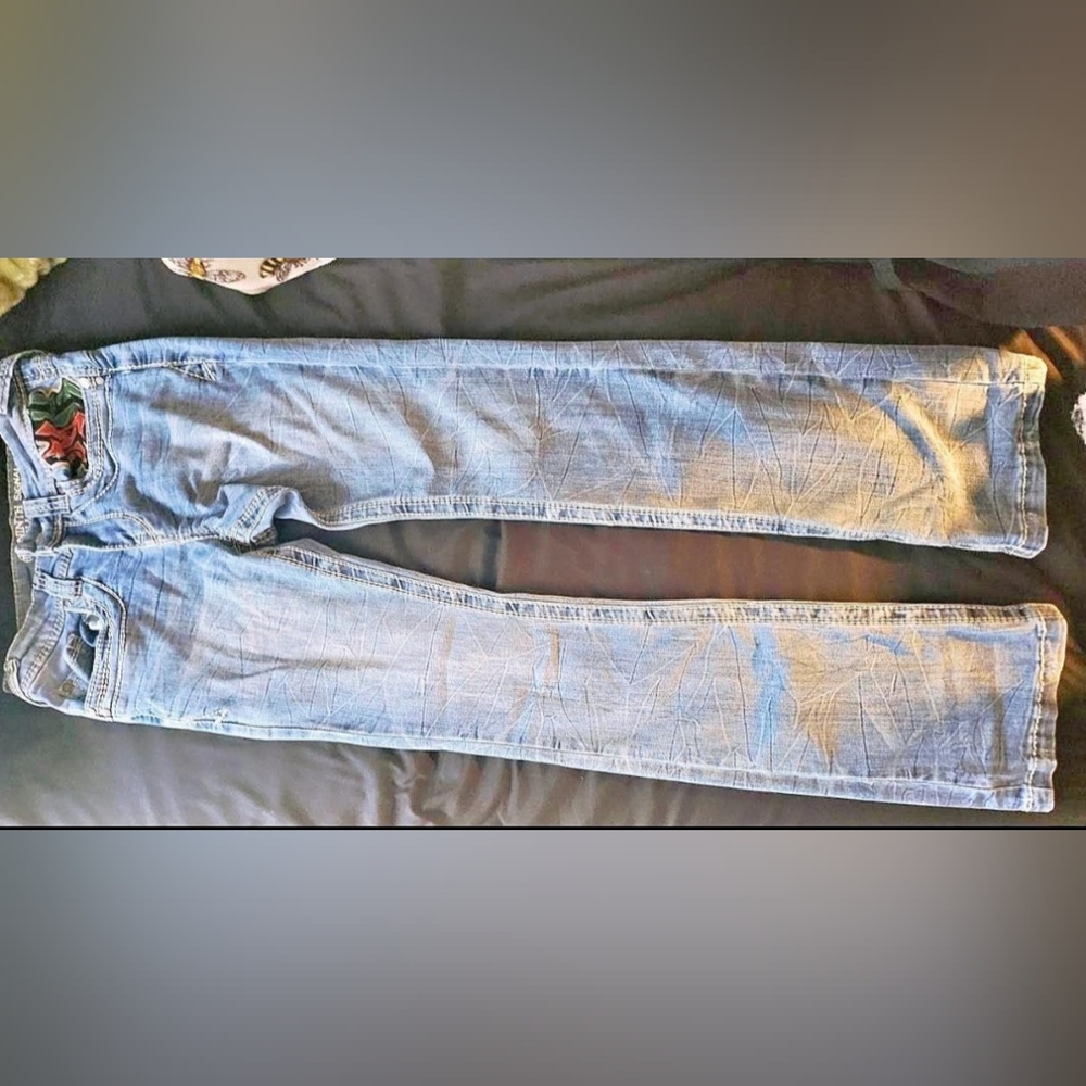 Ninth Signal light wash flare jeans with embroidered back pockets.
